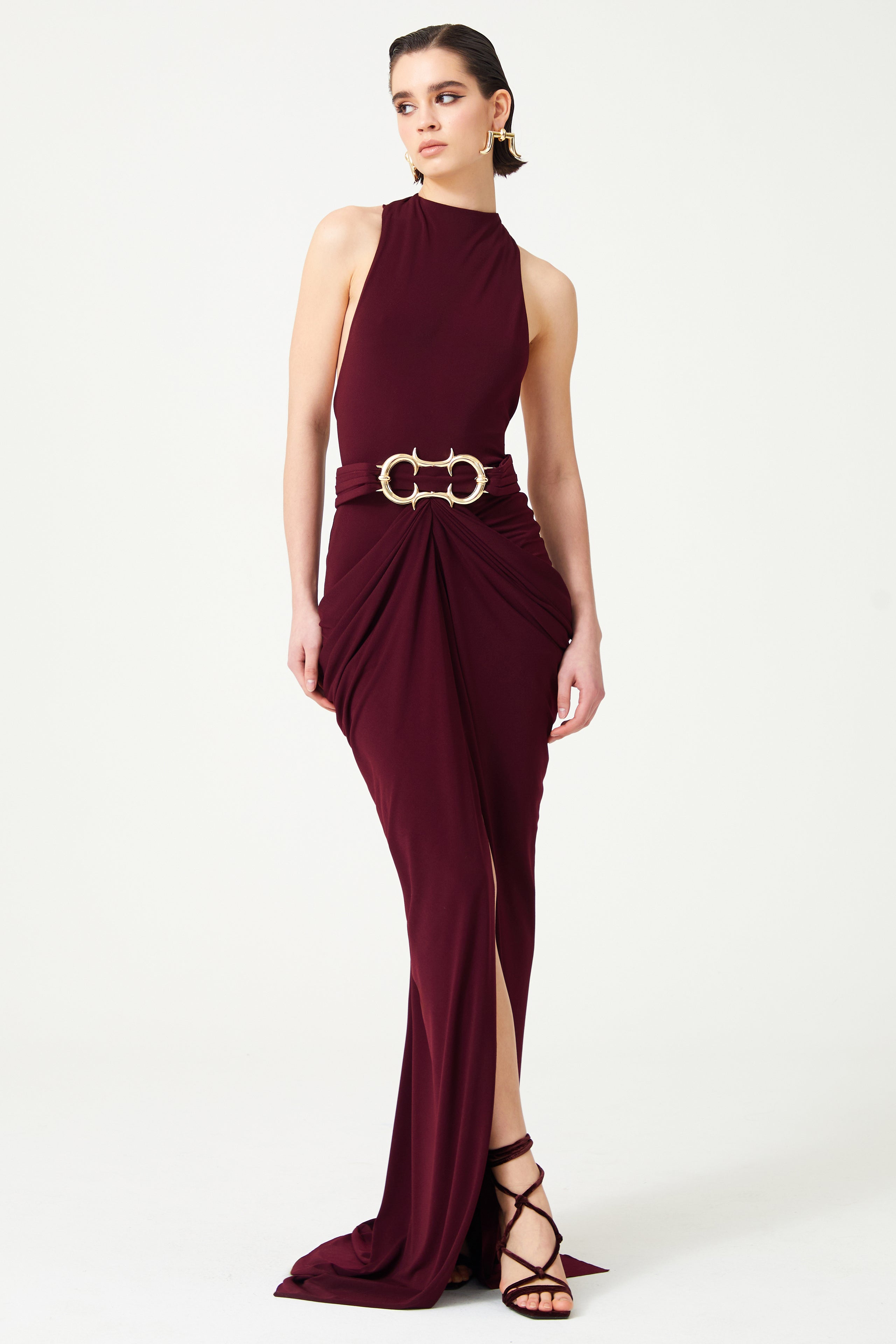 Burgundy Halter Neck Draped Backless Gown With Gold Buckle Detail RAISA VANESSA INT Burgundy Halter Neck Draped Backless Gown With Gold Buckle Detail RAISA VANESSA INT