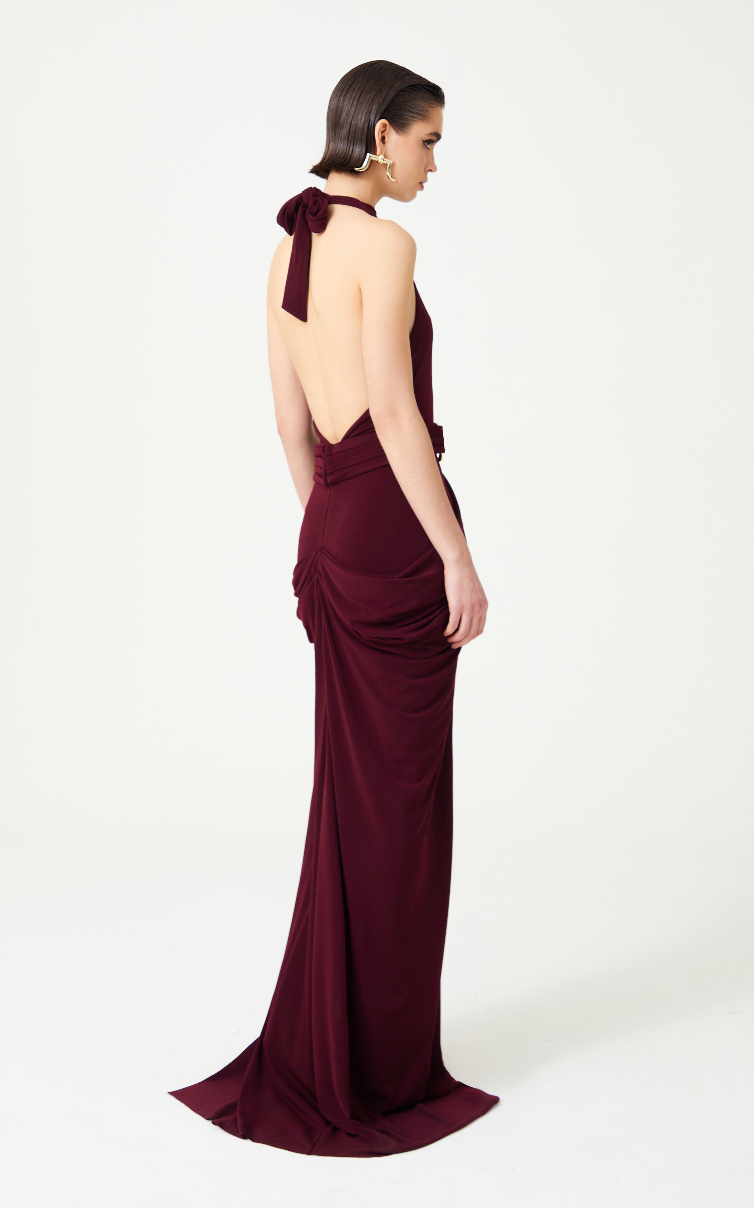 Burgundy Halter Neck Draped Backless Gown With Gold Buckle Detail RAISA VANESSA INT Burgundy Halter Neck Draped Backless Gown With Gold Buckle Detail RAISA VANESSA INT